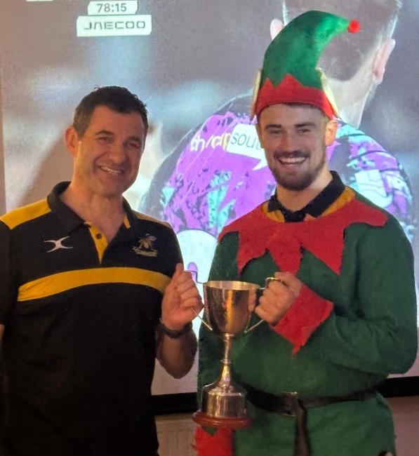 Saints skipper Nathan Foster (not an elf) collects the Johnny James Cup from Wasps chairman Dan Chesmer